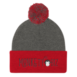 grey beanie with dark red cuff and pompom with Monkety Biz logo in black curvy font on the front cuff, including Monkety Monk cartoon monkey face between Monkety and Biz