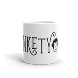 white mug with black and white MonketyBiz logo in curvy font including Monkety Monk face. View shows "NKETY" and the monkey's face. 